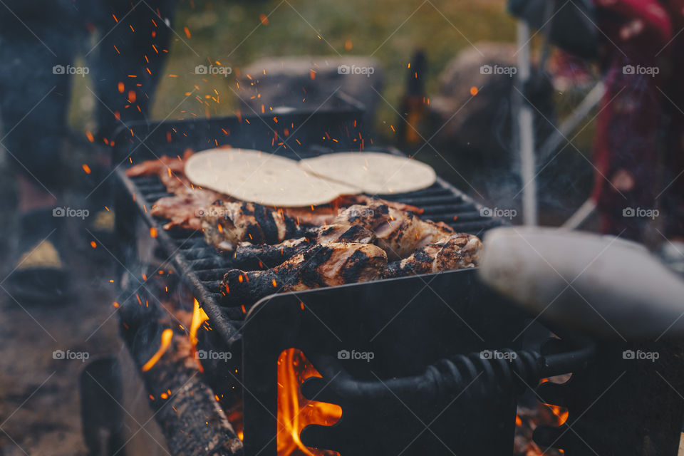 Grilling meat while camping 