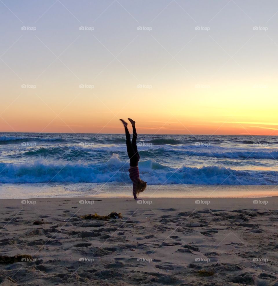 Hand stand at sunset