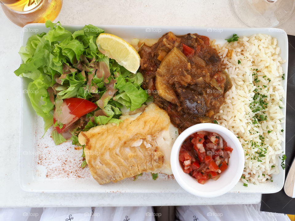 Plate with rice fish and salad