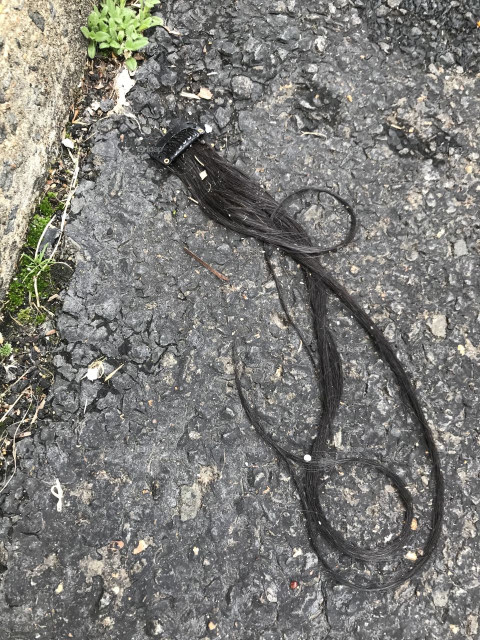 A nasty old hair extension on the ground
