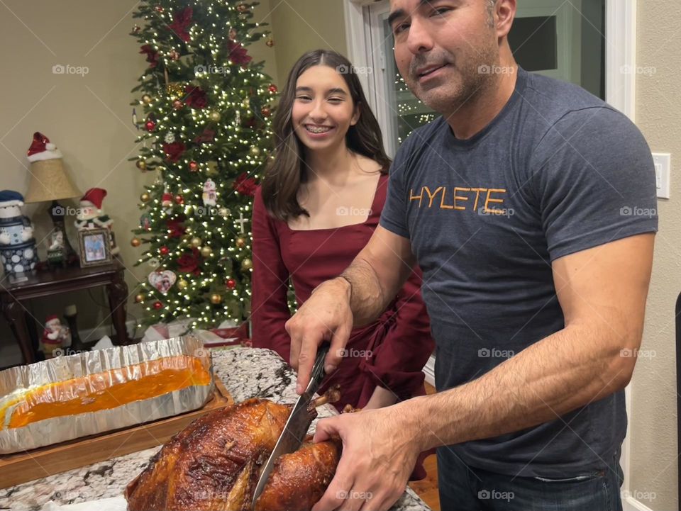 My oldest daughter and husband carving the Christmas turkey