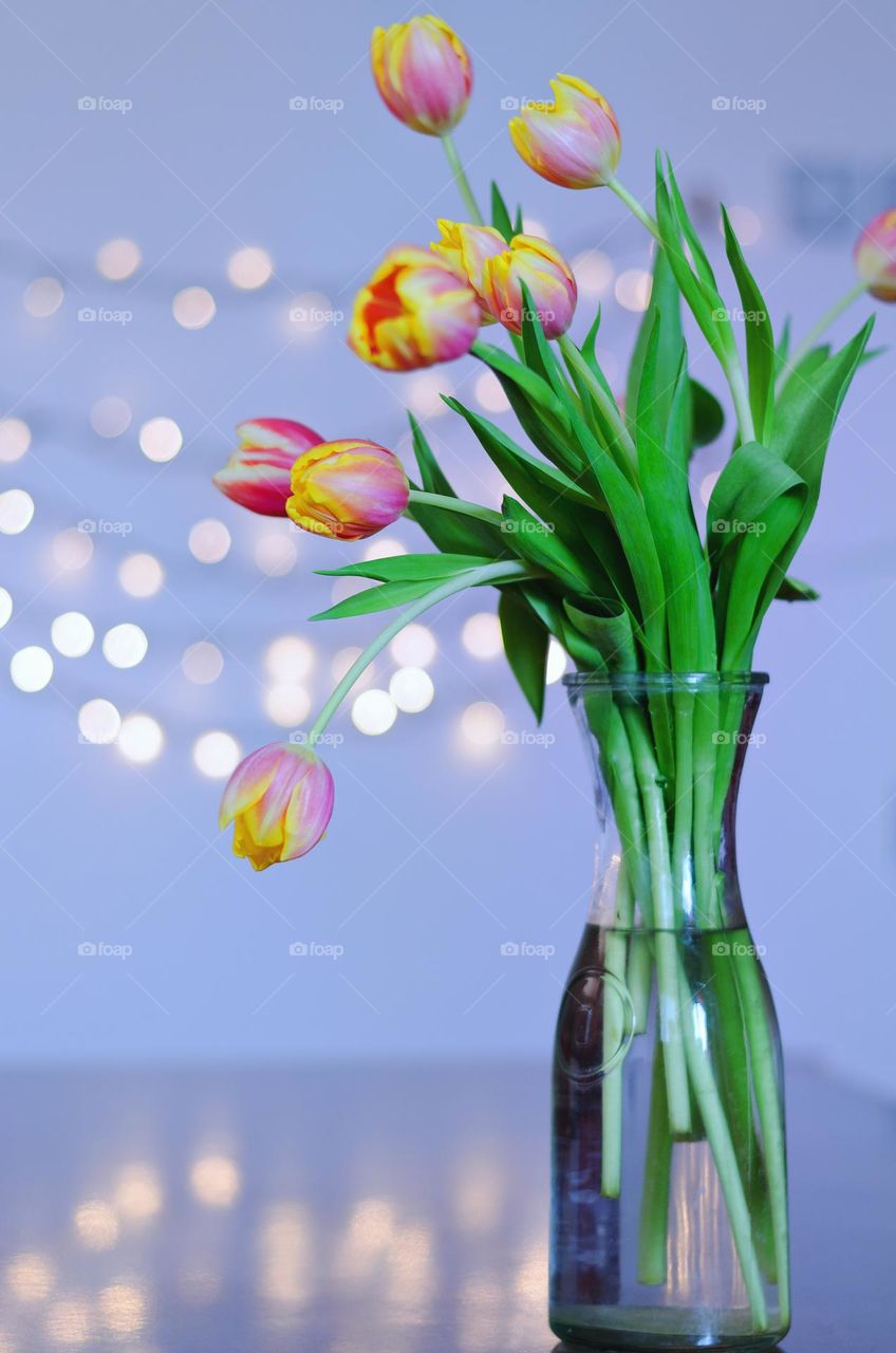 Top view of beautiful blooming flowers,  tulips in a vase at the table.  Spring time.