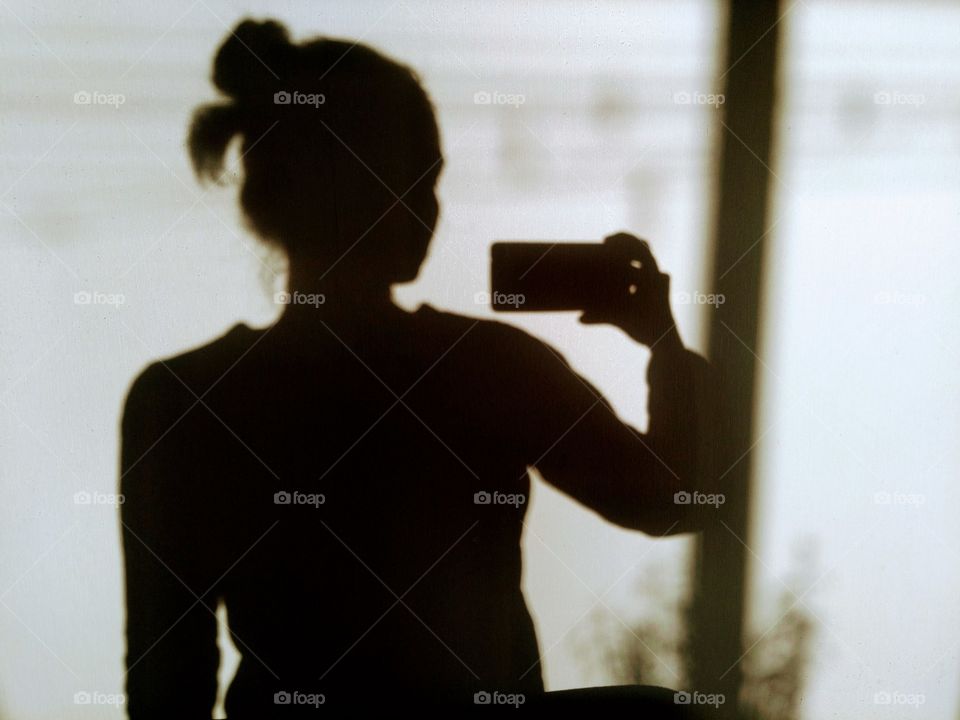 light and shadows woman in the room on a wall background, abstract portrait