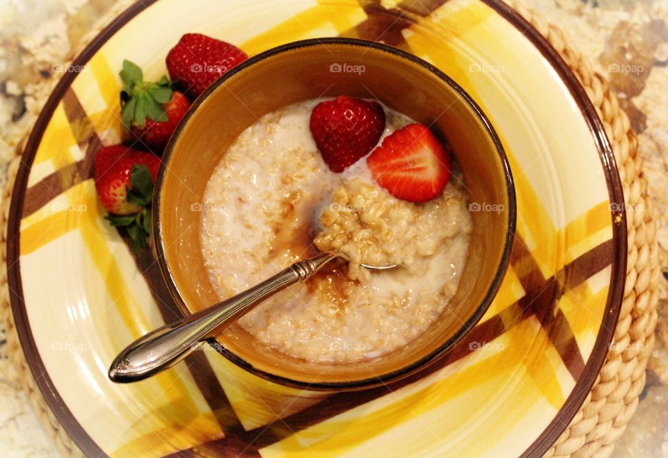 Oatmeal with strawberries,cream, and brown sugar 