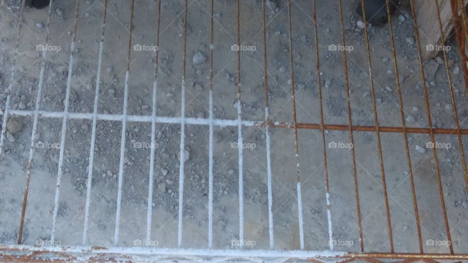 Rusting steel shelving rack stored out of doors.