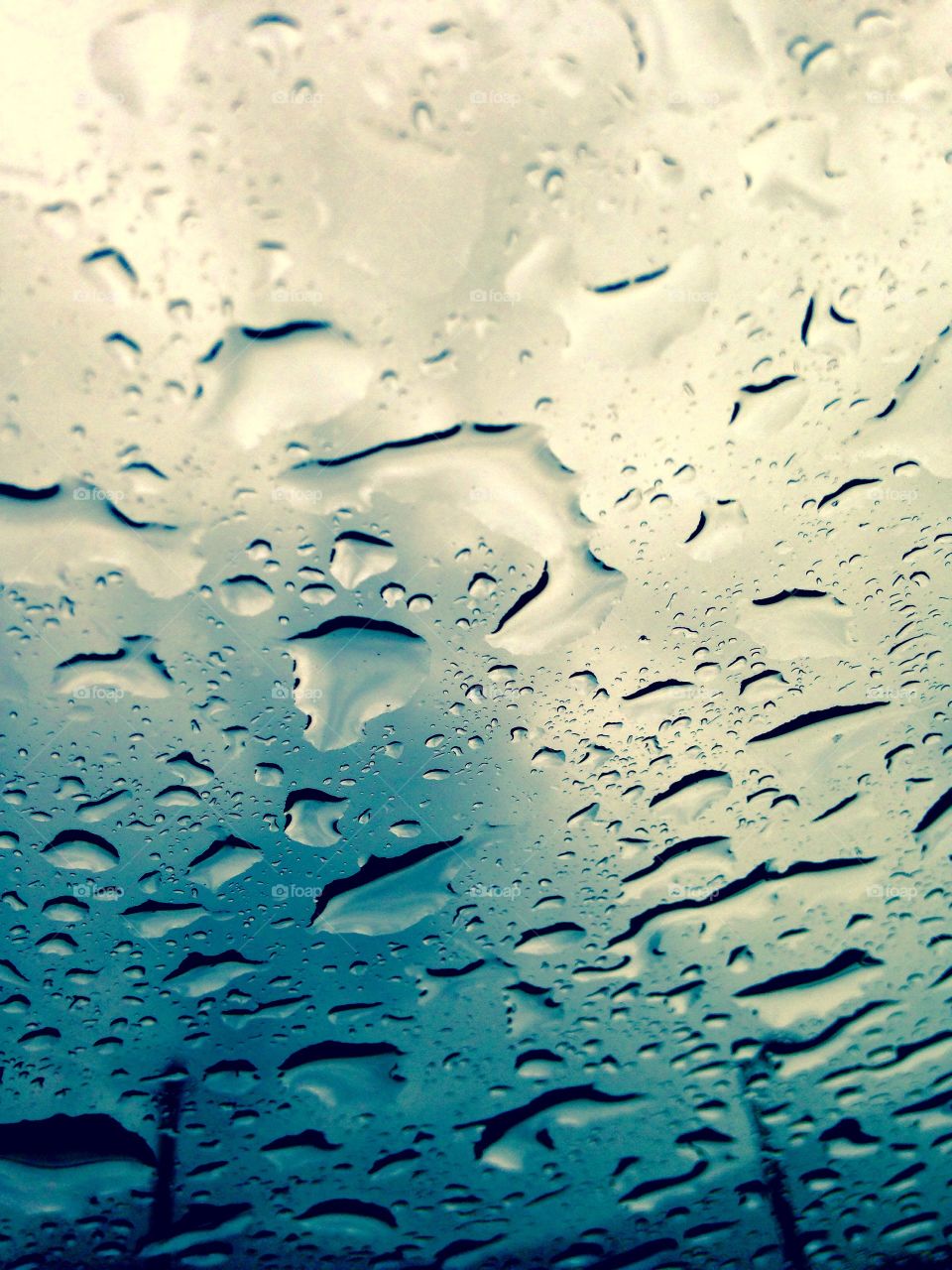 Raindrops on a cloudy day, on top of my sunroof.