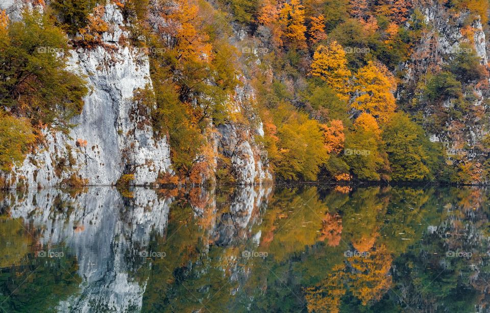 Beautiful autumn scenery with reflection of trees in lake