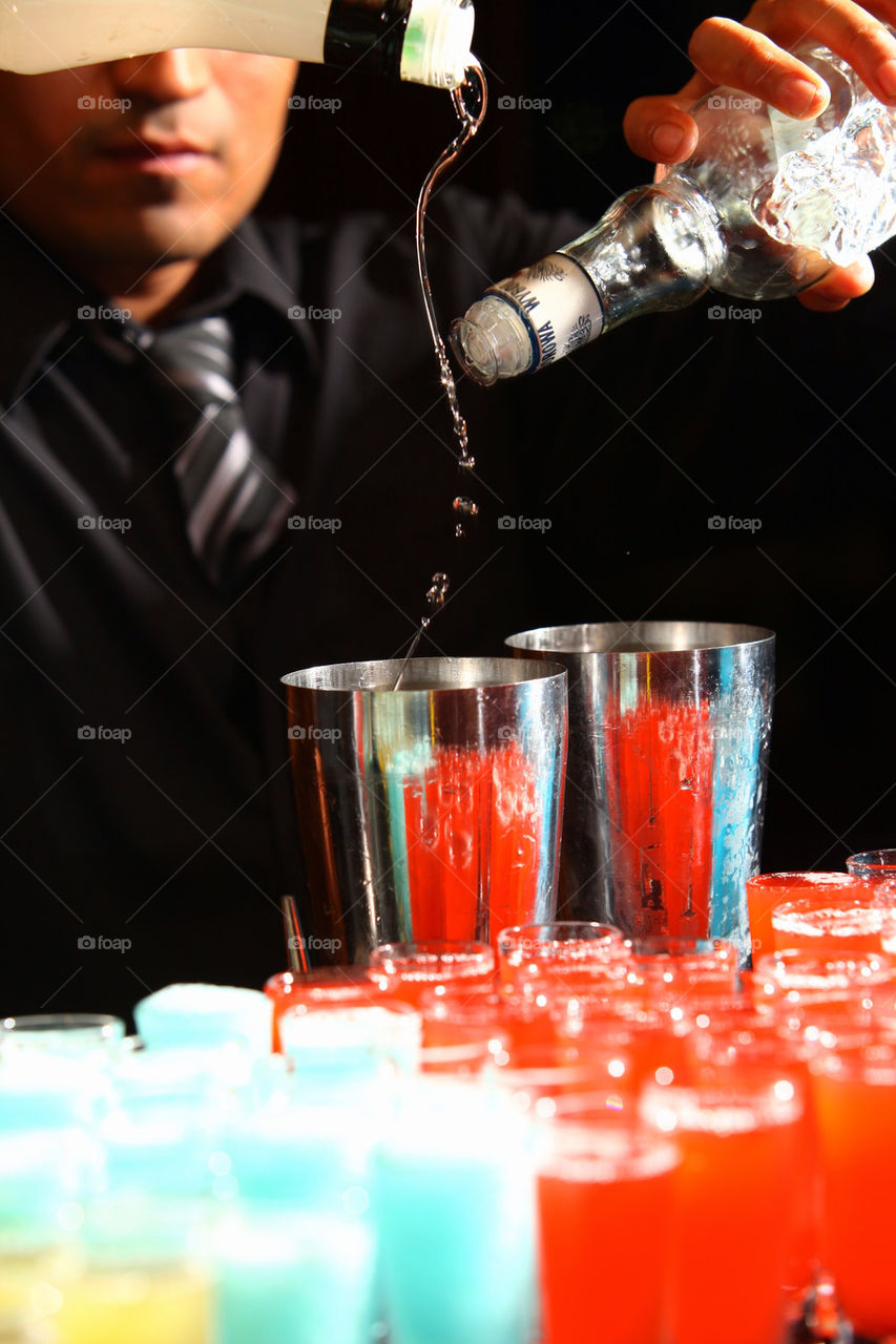 Barman fixing some drinks at a party