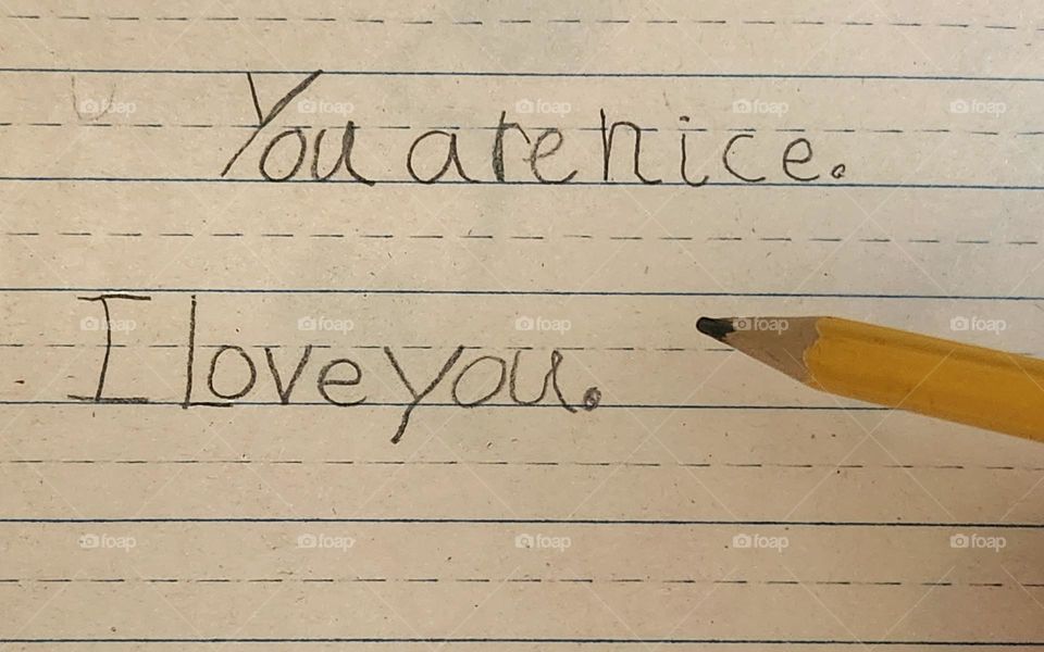 kind message written in pencil on lined paper by child in school to a friend or family member