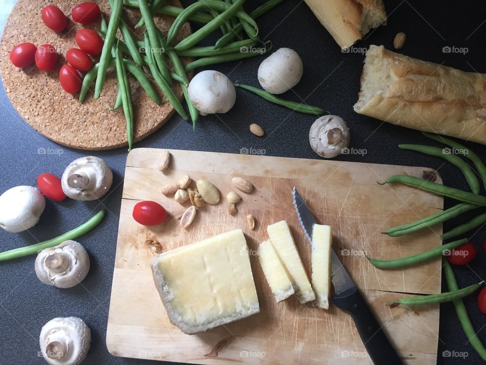 Sliced cheese at the wooden board. Healthy meal. Breakfast