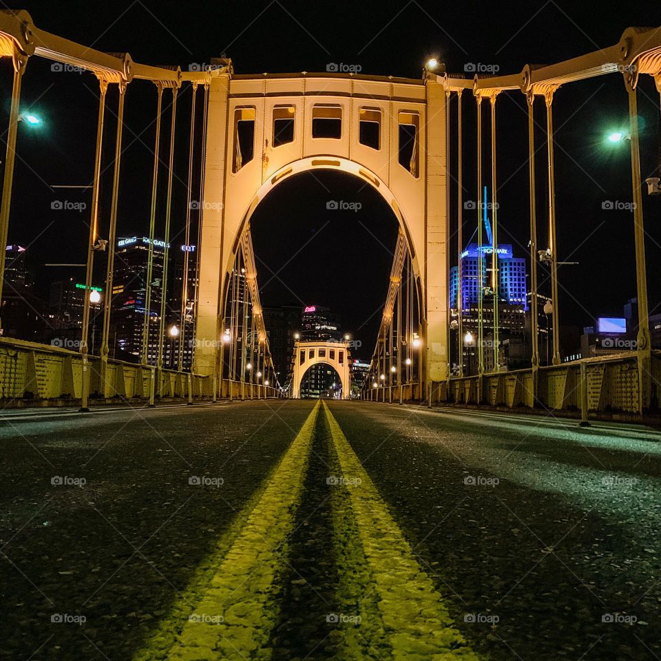 Night time in Downtown Pittsburgh, PA on a lit bridge