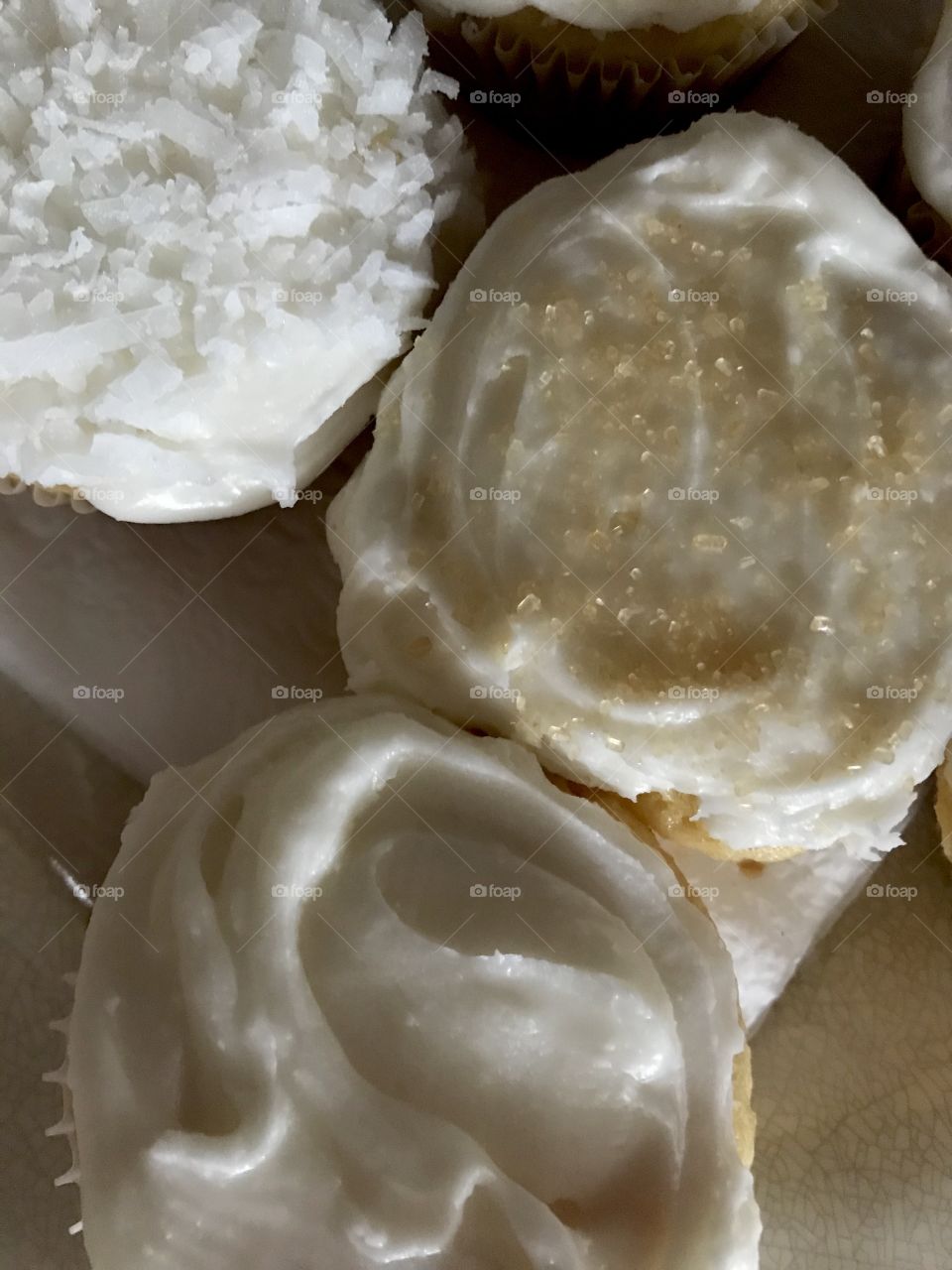 Close up of homemade baked white vanilla coconut cupcakes