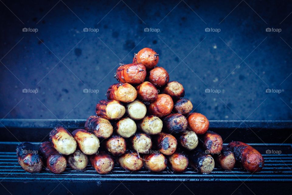 Sausage stack. Stack of sausages on a BBQ 