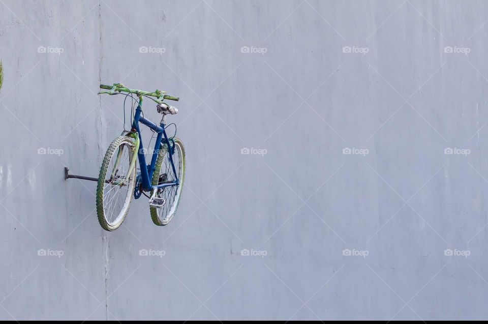 An lonely bicycle on the wall