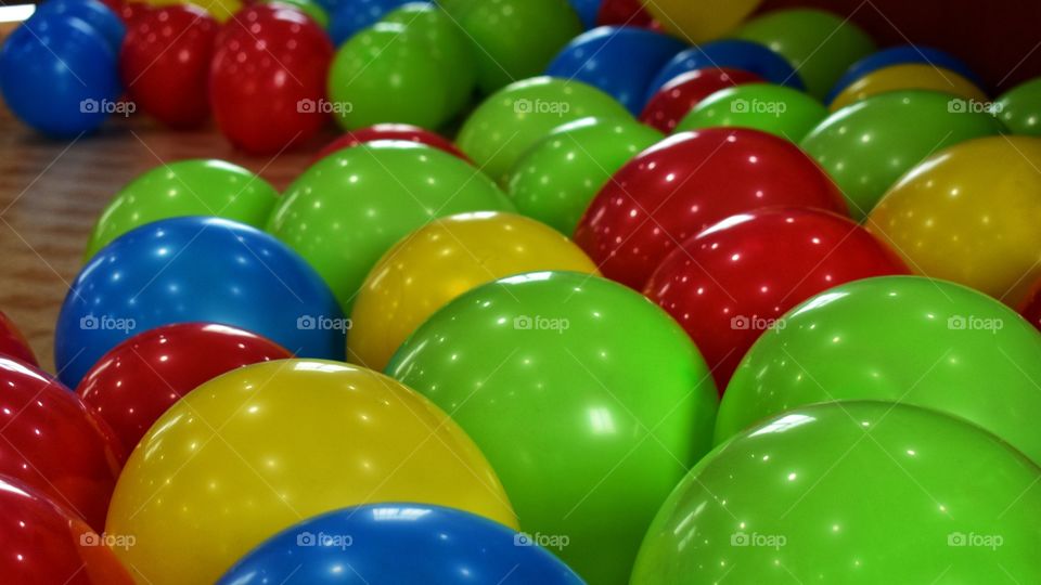 colourful balloons on ground with white light reflection