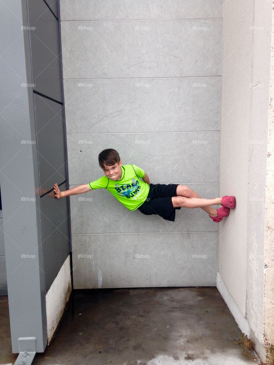 Portrait of a boy between two walls