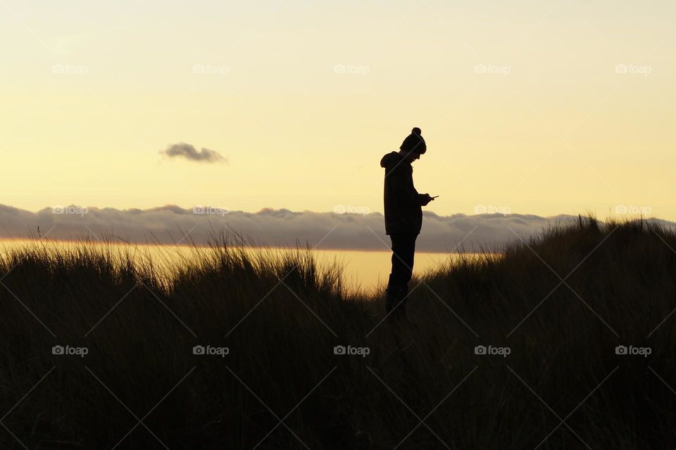 Scrolling through photo’s for Foap Missions I found this one of my son trying to get a signal on his phone on Holy Island … love his pom pom silhouette !