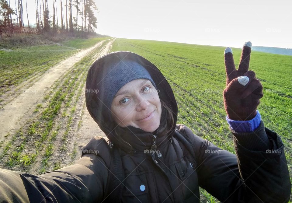 selfie girl walk on the nature green field