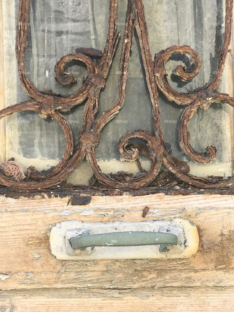 Old rusty ornaments on a wooden door 