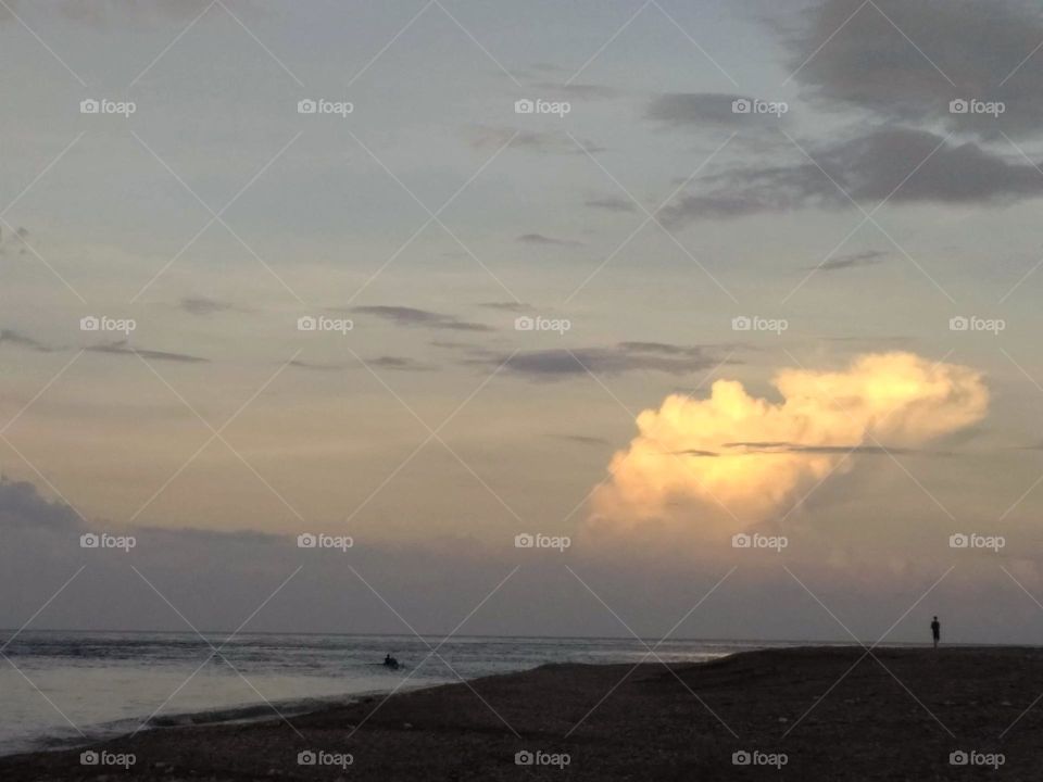 A clear cloud on the horizon near sunset time