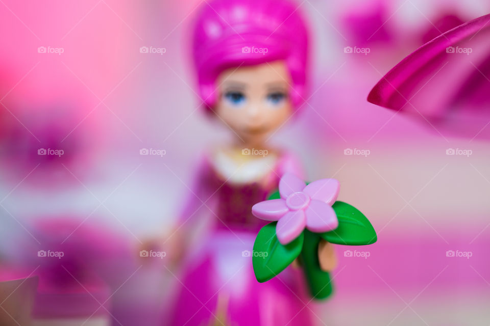 Pink - image of Lego girl with pink hair, pink dress and pink flower close up