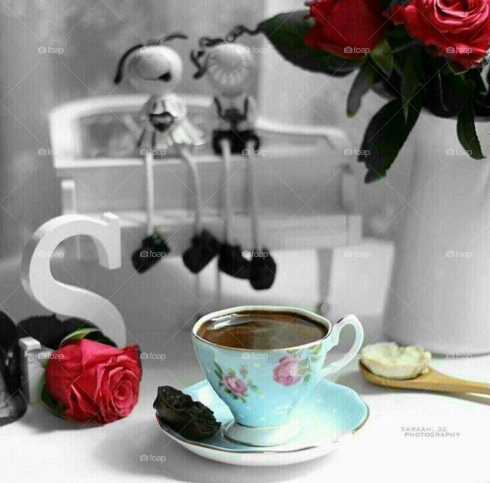 Serve a cup of coffee with flowers and orange slices