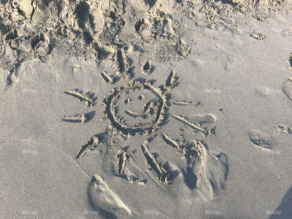 Enjoying summertime and drawing on the sand at the beach in Ulcinj, the state of Montenegro.