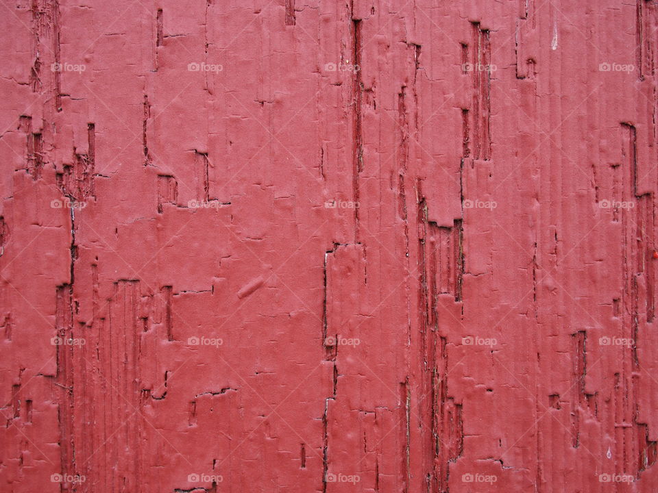 Red paint on old wooden wall