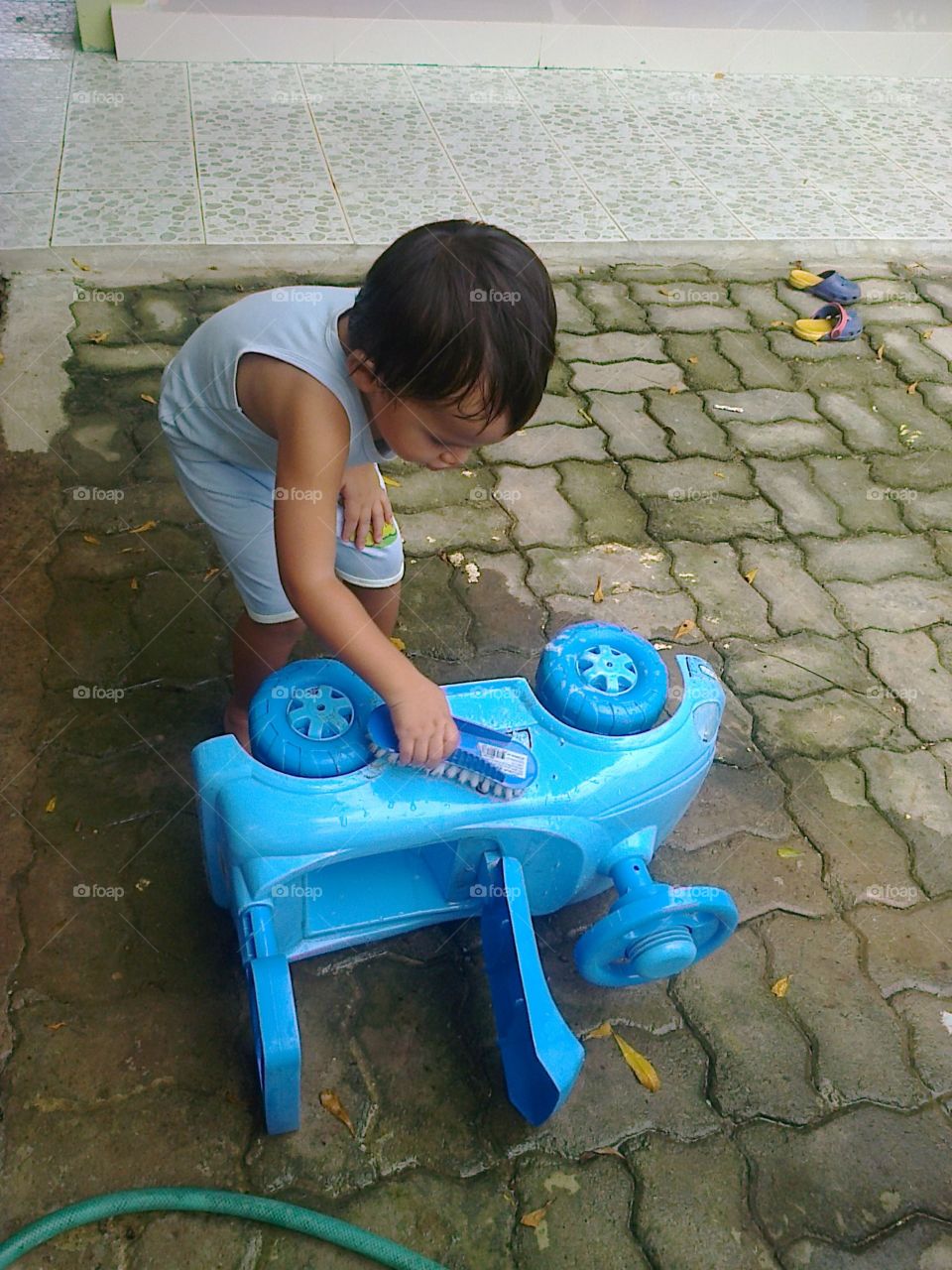 kid cleaning his toy car. child acting like adult,  follow daddy