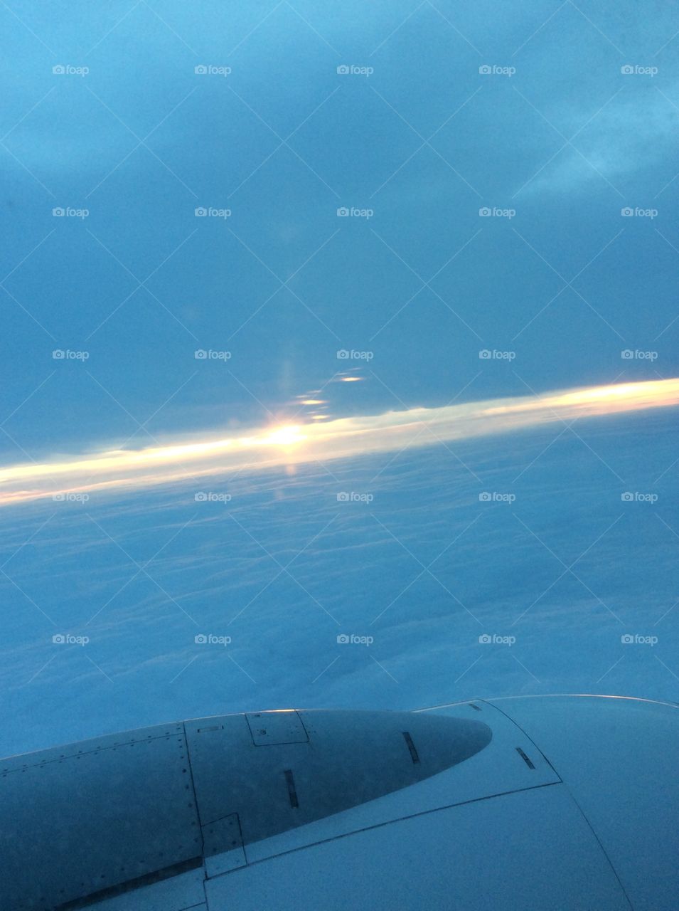 Airplane wing over the clouds 