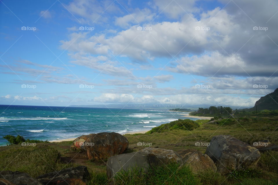 Landscape across the north shore that stretches for miles and miles. Gorgeous turquoise waters and fluffy clouds 