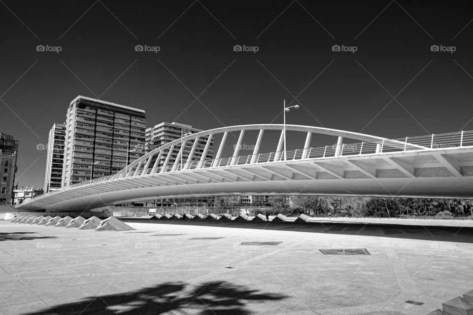 Puente de la Peineta known as the 'Ornamental Comb' bridge spanning across dry riverbed transformed into city park. Below is metro station. Valencia. Spain.