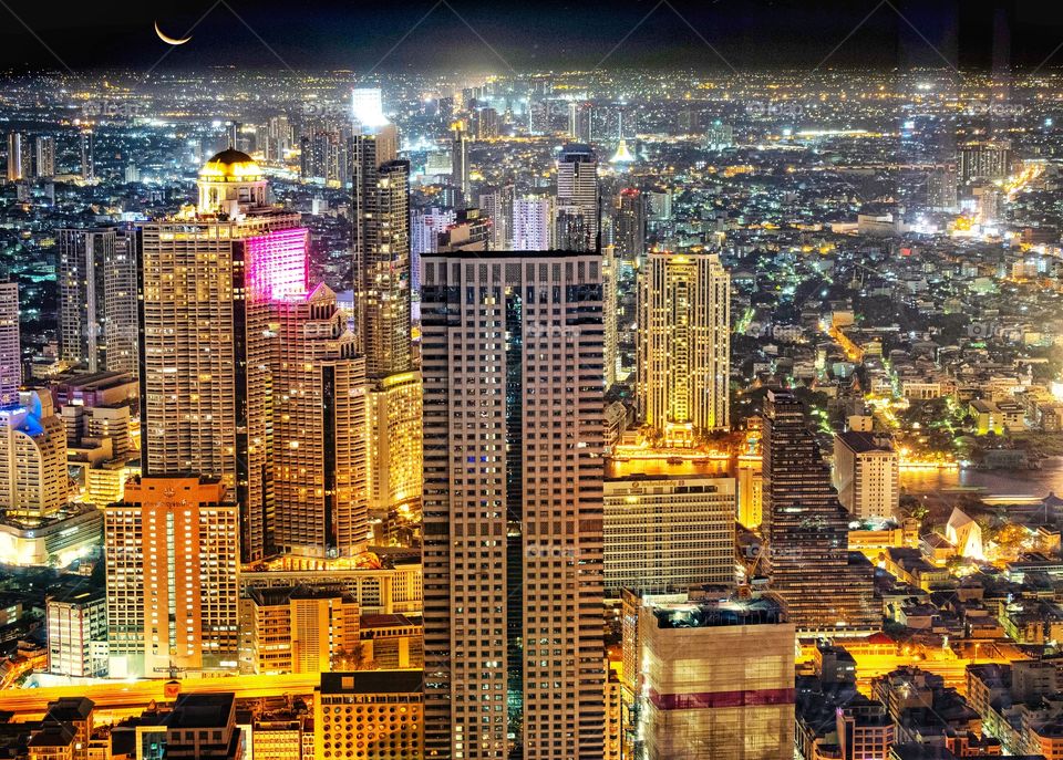 Beautiful night light of building in central city Bangkok , Roof top Mahanakorn building Bangkok Thailand 