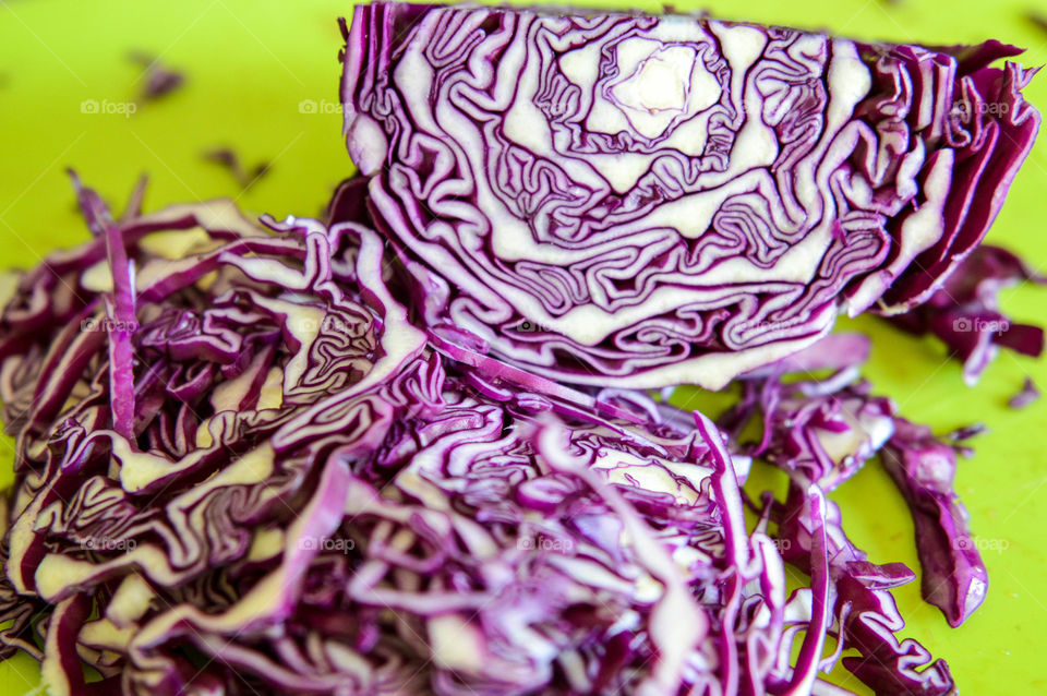 Sliced red cabbage on a green cutting board