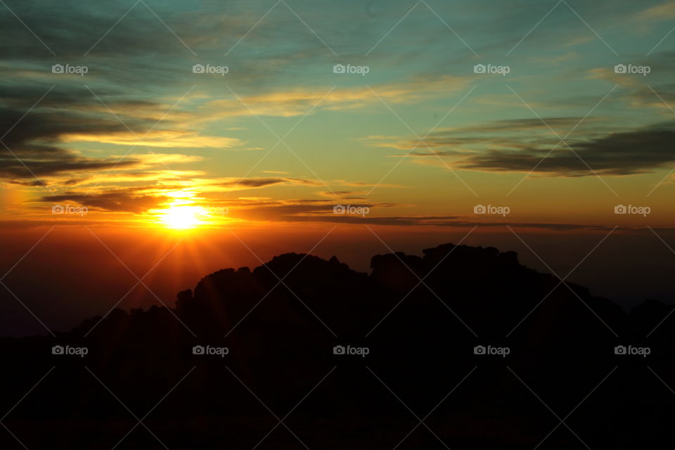 sunset in the mountains. sun rays from mountain at sunset