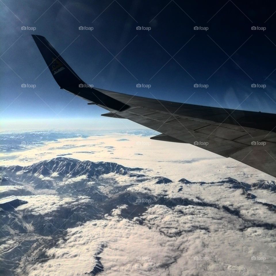 Пейзаж из самолета с видом на снежные горы 