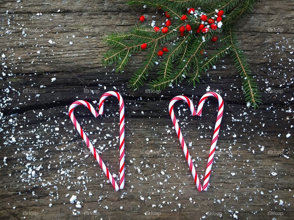 Heart shape candy cane and christmas tree on wood