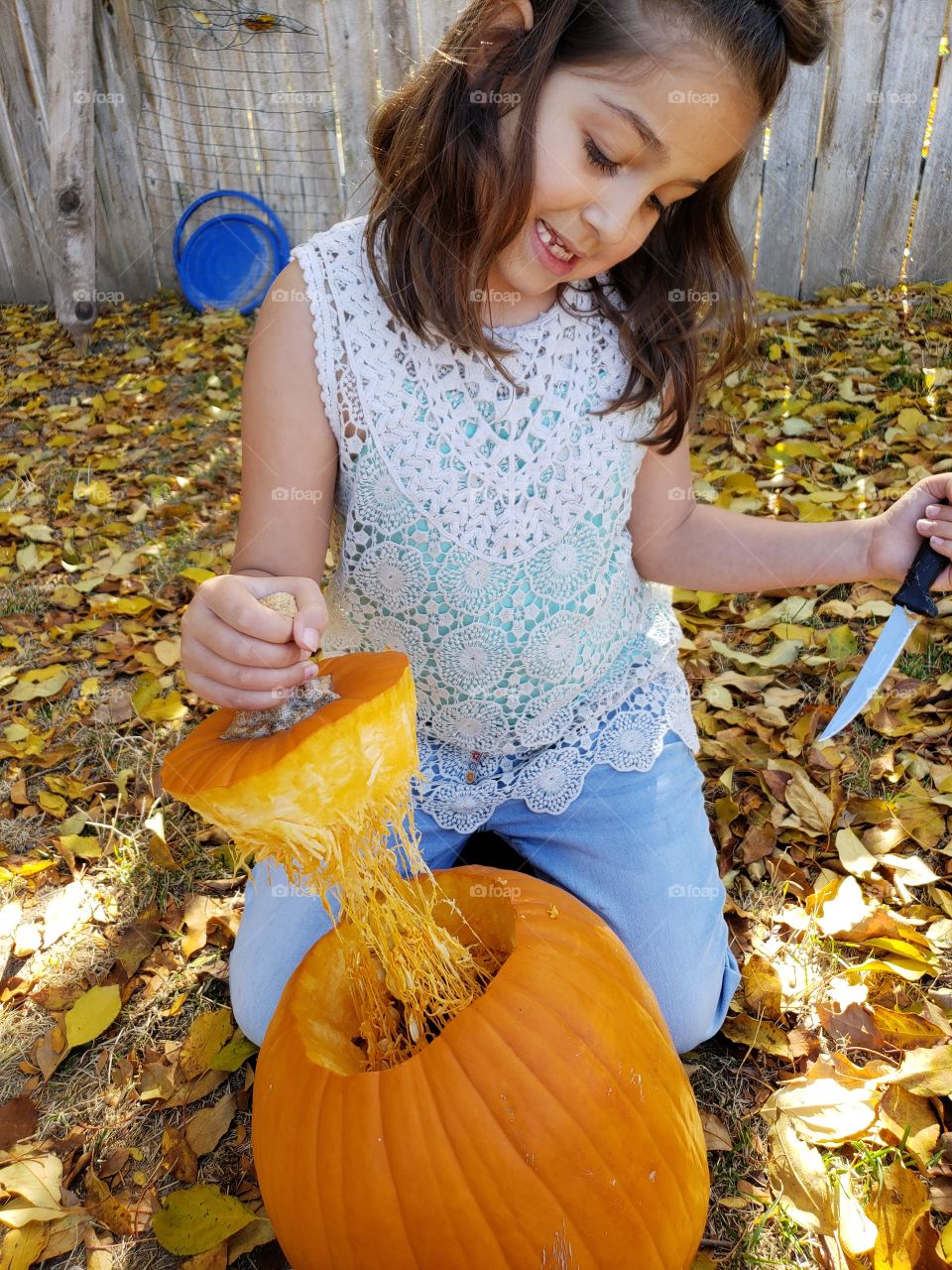 gutting a pumpkin cutting top with knife