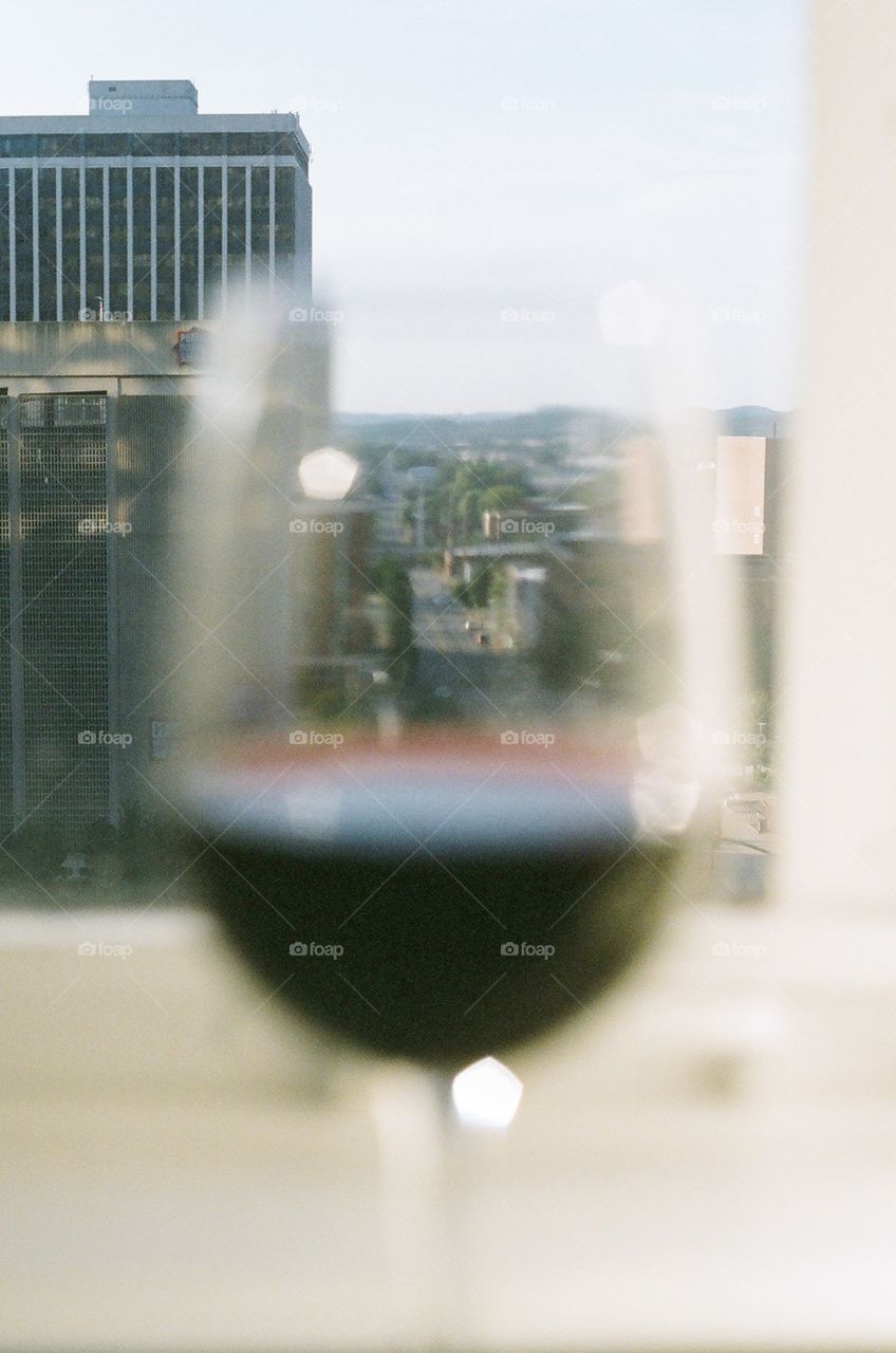 View of city through and around wine glass 