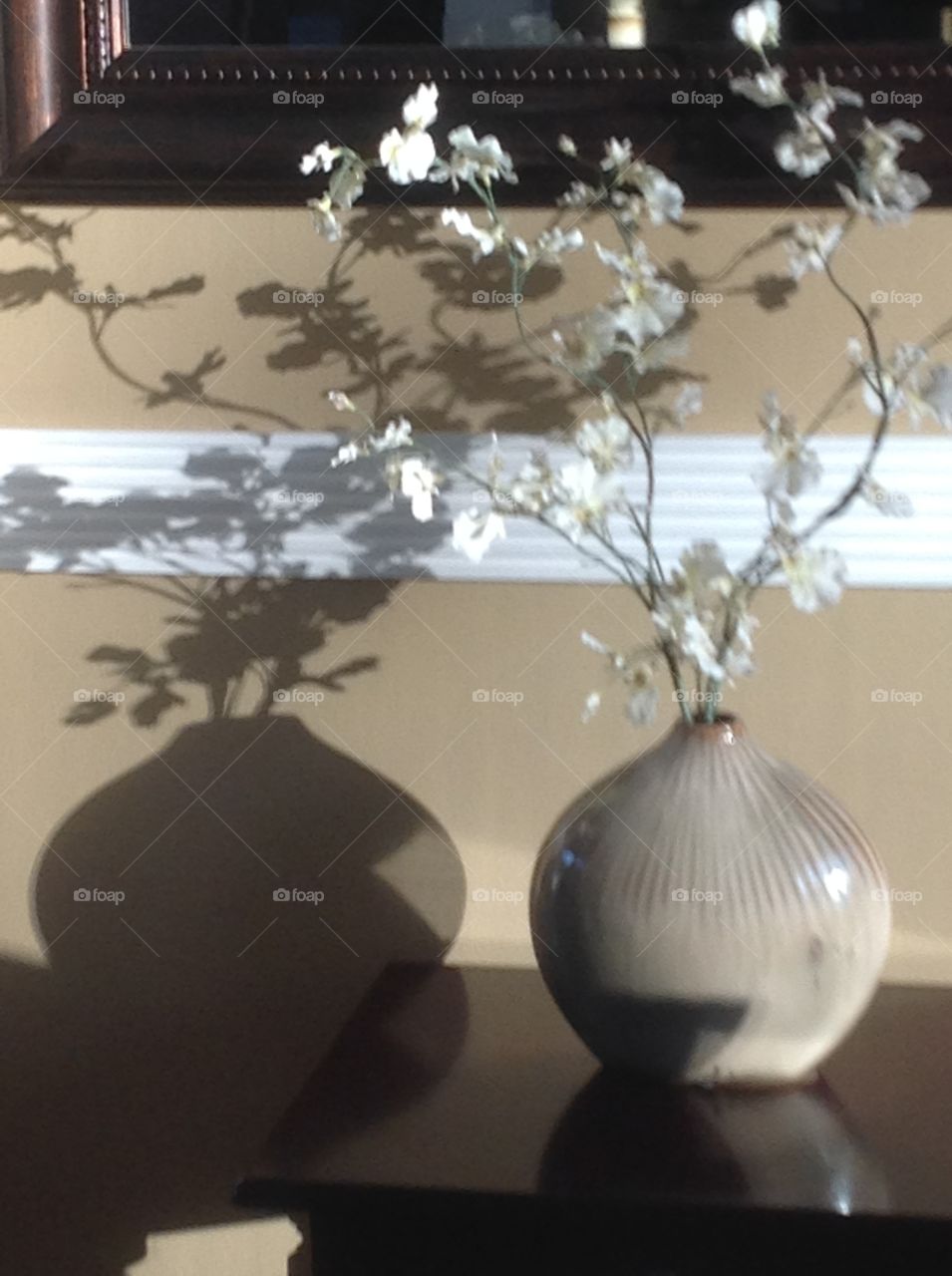 Reflection of sunlight off a vase of flowers.