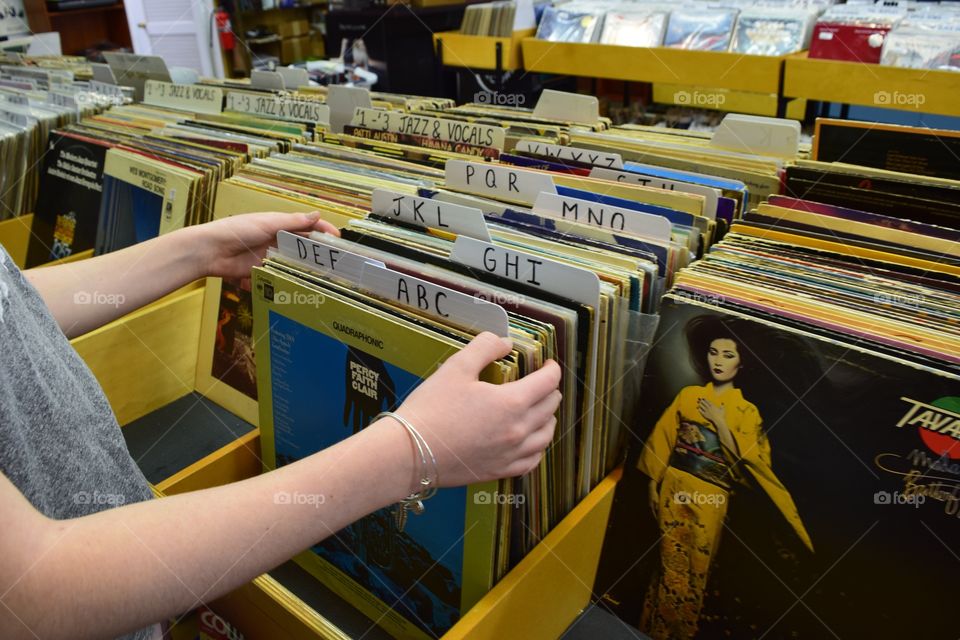 A girl looking through the vintage albums.