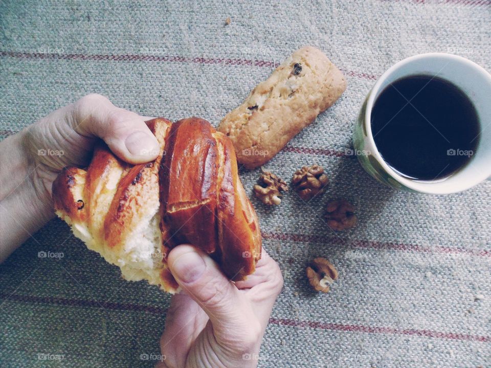 Woman's hands breaking bread