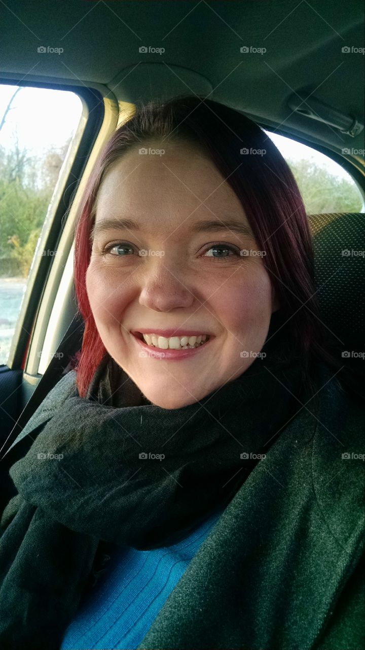 Portrait of a woman sitting in car