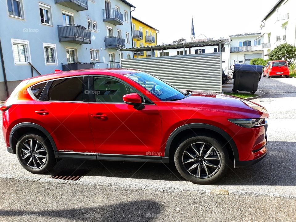 Beautiful red car in the neighbourhood