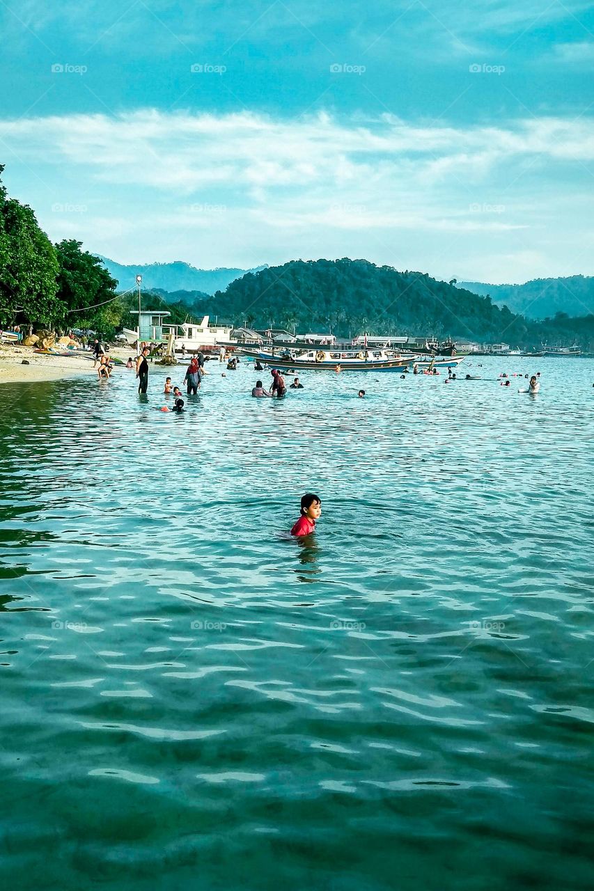 Bandar Lampung, Lampung, Indonesia - October 11, 2023: Mutun beach is full of visitors bathing at Lampung, Indonesia