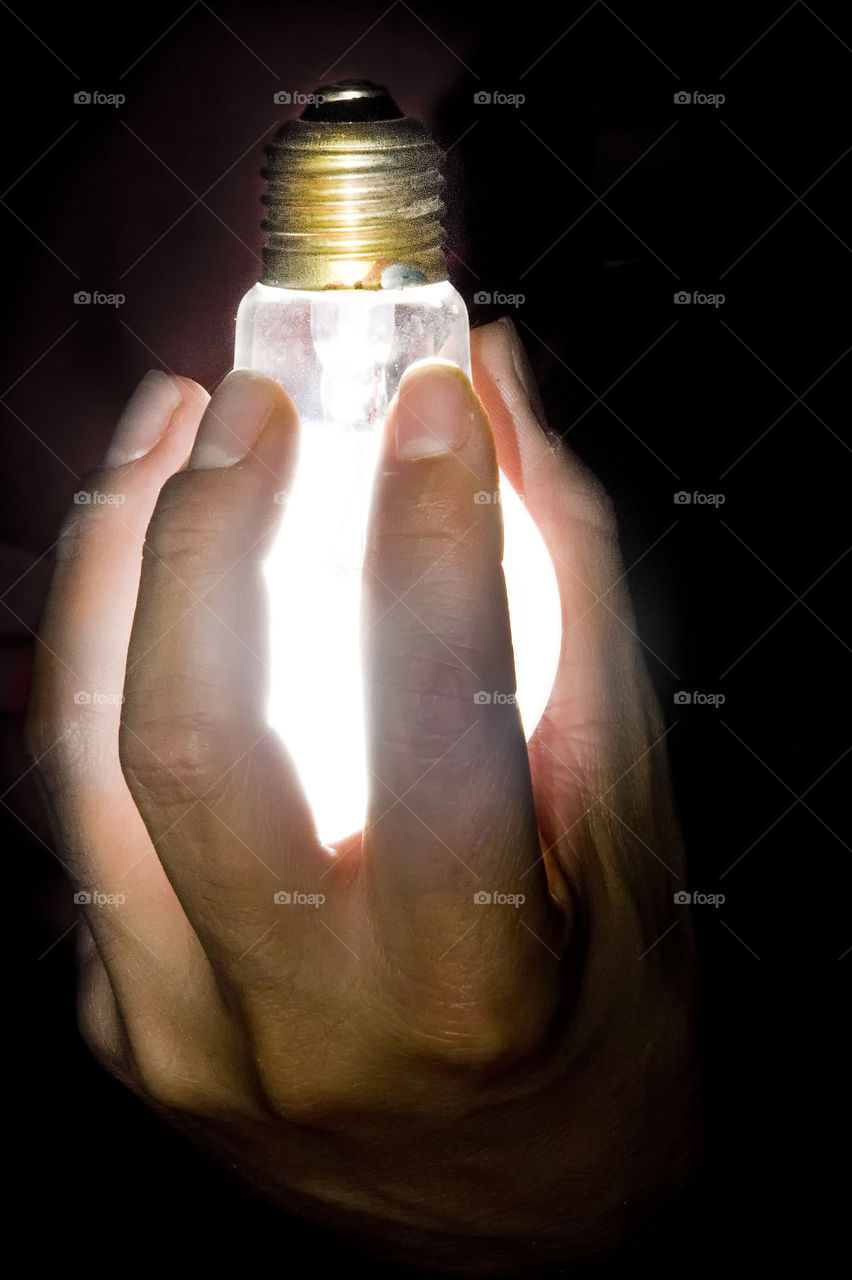 Light in my hand . Bulb lighting in hand 