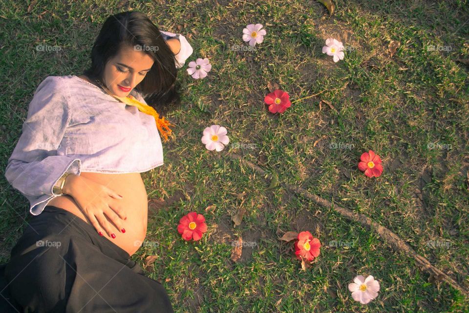 Pregnant woman lying on grass