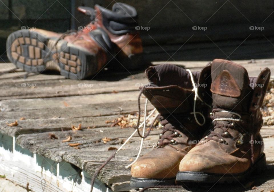 Boots resting on the cabin porch after the hike in