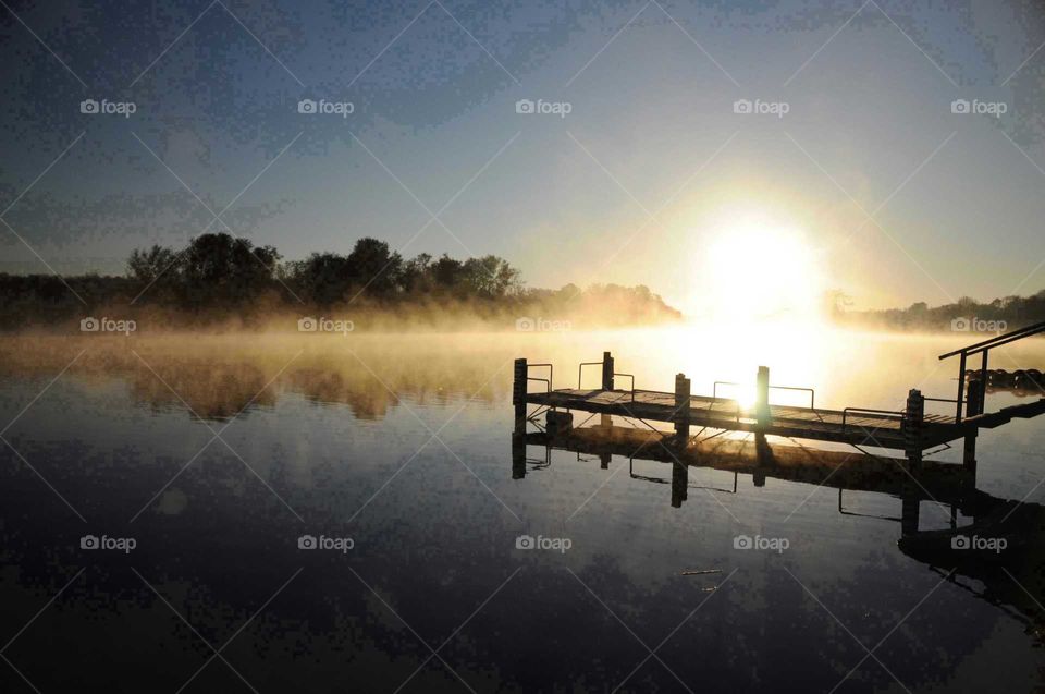 Jetty reflecting on a misty Vaal river near Orkney South Arica at dawn