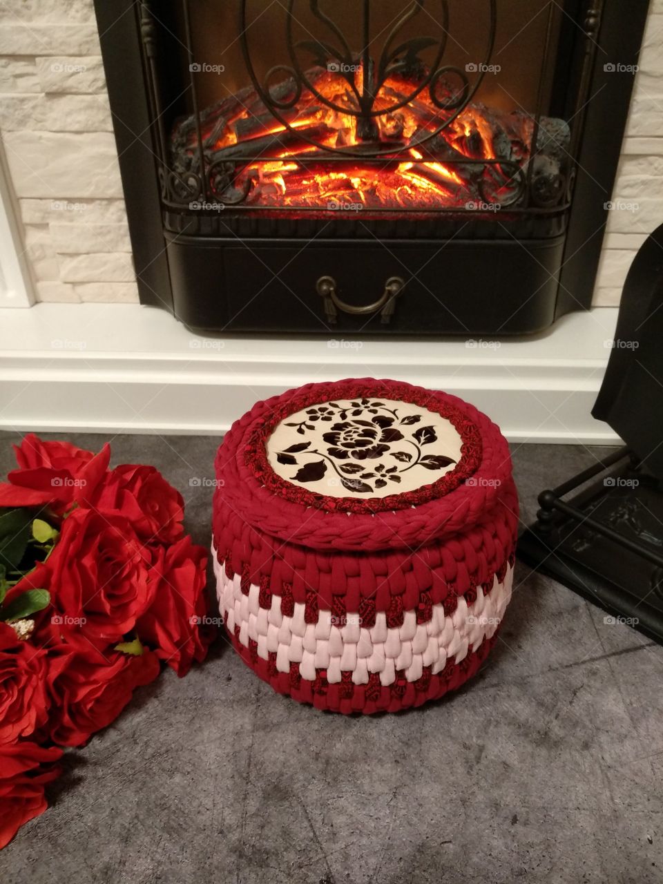 red basket and flowers by the fireplace